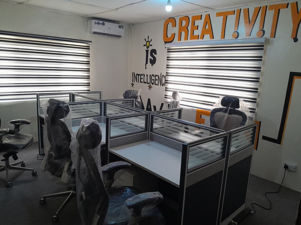Co-working studio at Minaret Talent Academy with workstations and the Creativity is Intelligence wall